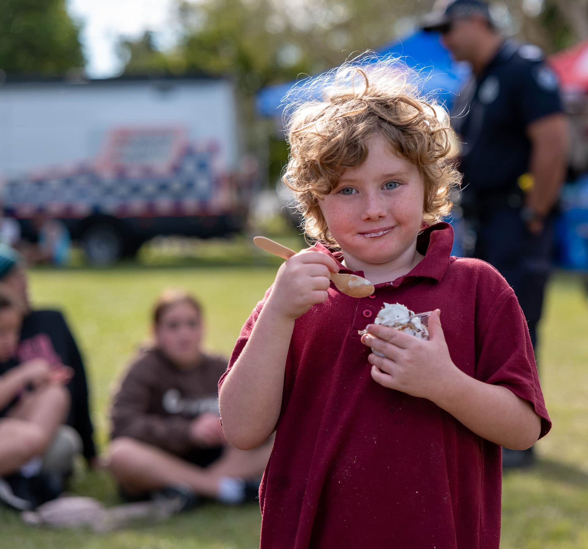 Child enjoying food at CAOS community festival in Crestmead Queensland