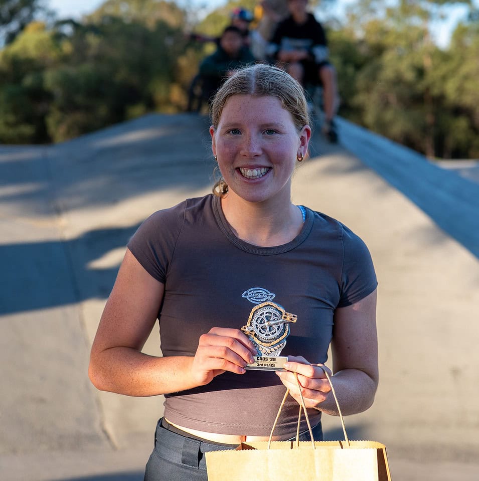Smiling attendee holding a prize at the Crestmead Annual Outdoor Spectacular community event in Queensland