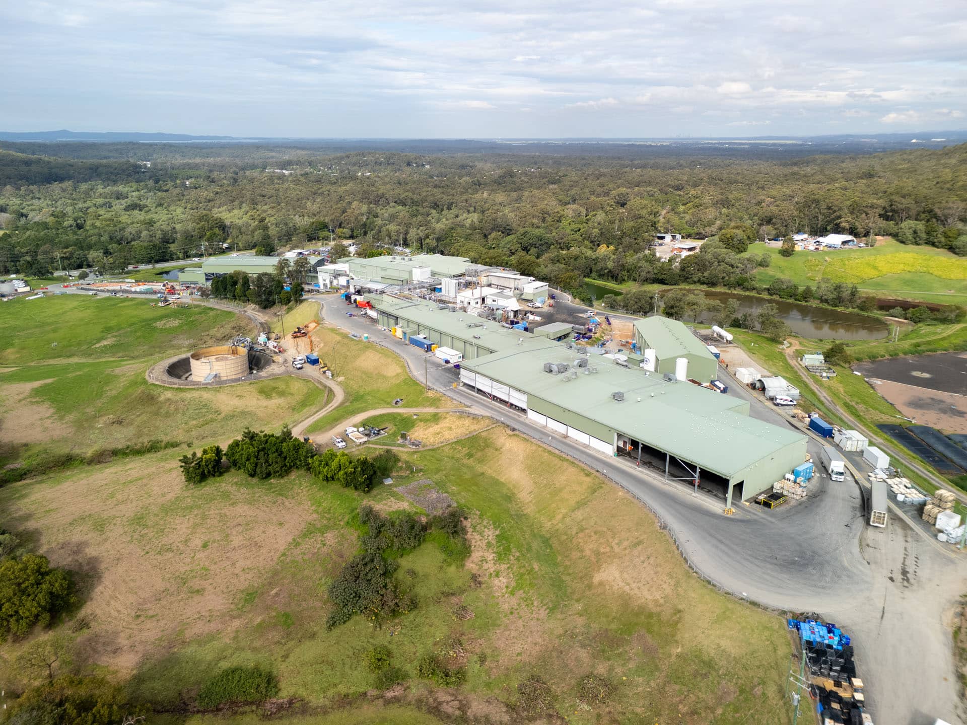 Wide aerial view of the Golden Cockerel facility and surrounding terrain at Mount Cotton, Queensland