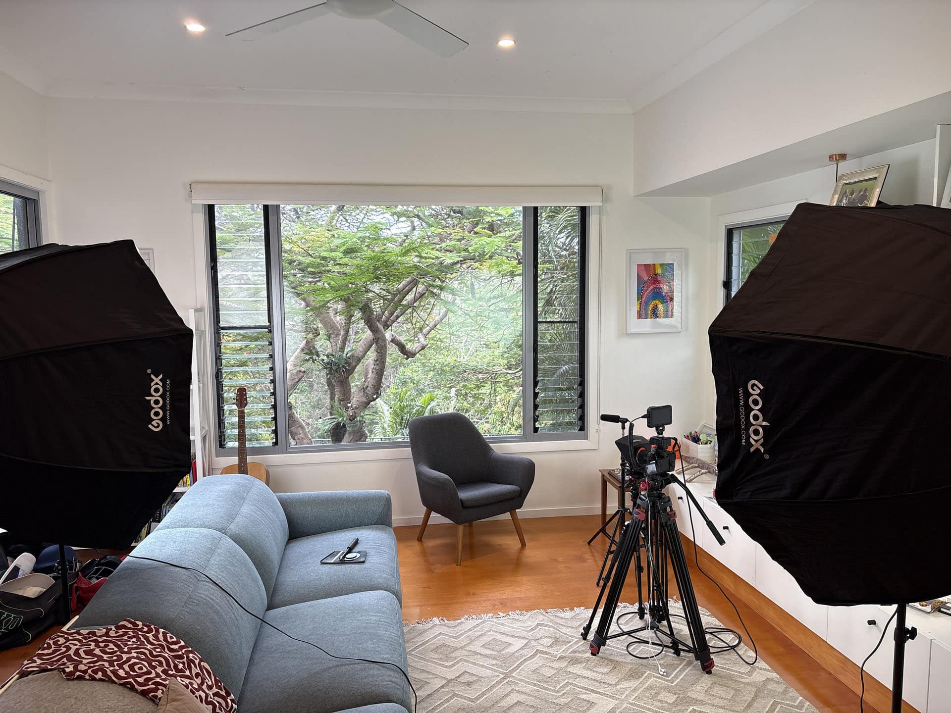 Video production setup with lighting and camera inside a modern indoor location