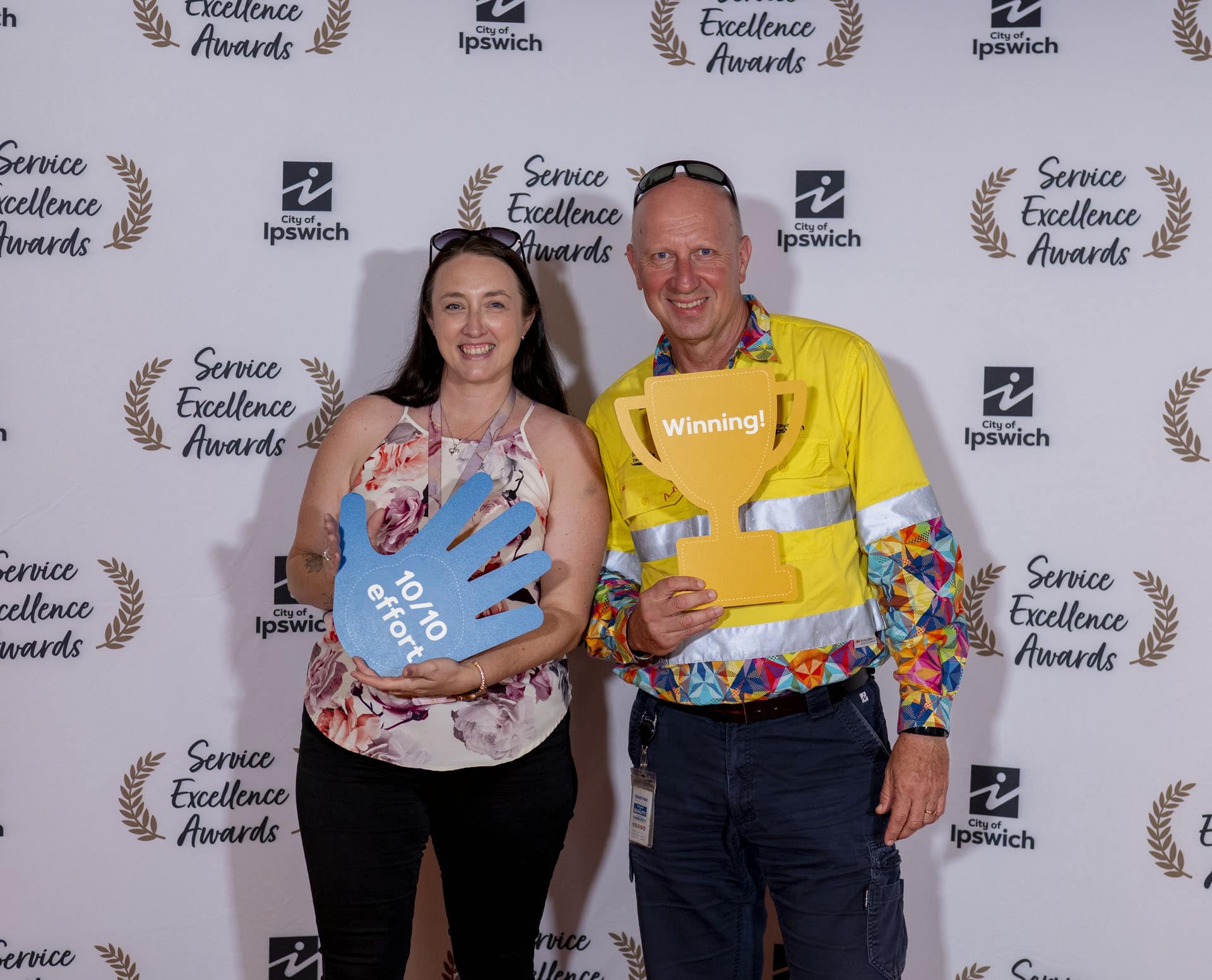 Award recipient photographed at branded media wall during Ipswich City Council Service Awards event in Ipswich, Queensland.