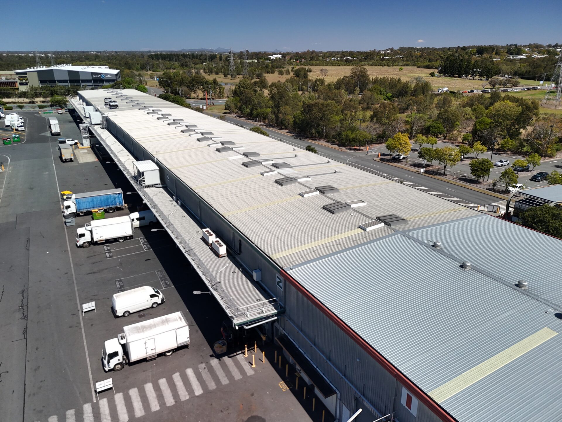 Drone roof inspections Brisbane – aerial overview of commercial warehouse rooftops at Brisbane Markets, Rocklea, photographed for Eatons